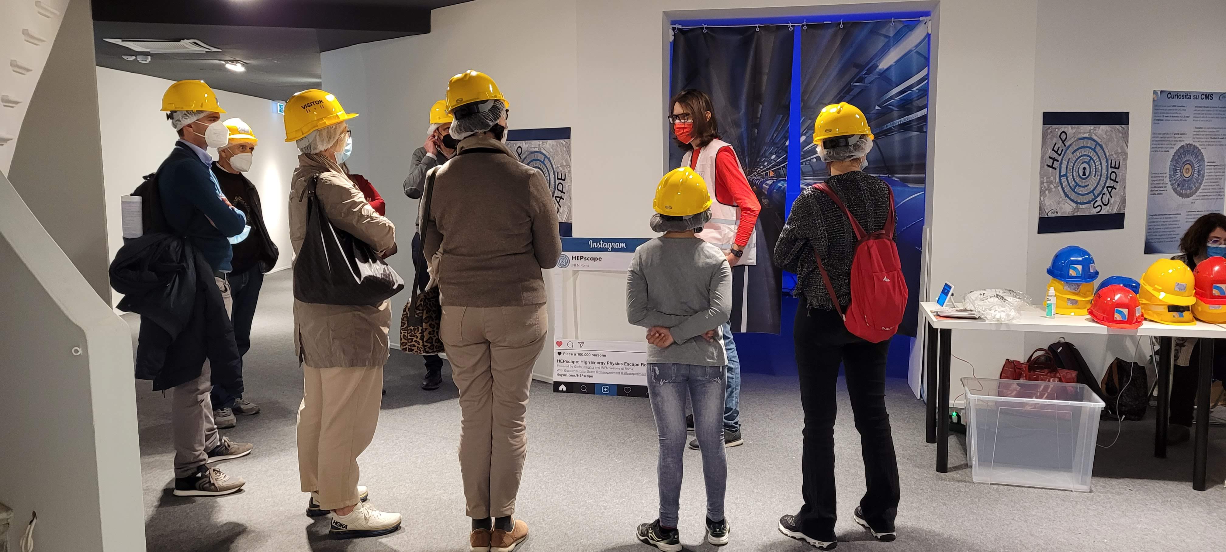 People in the entrance of the escape room wearing helmets