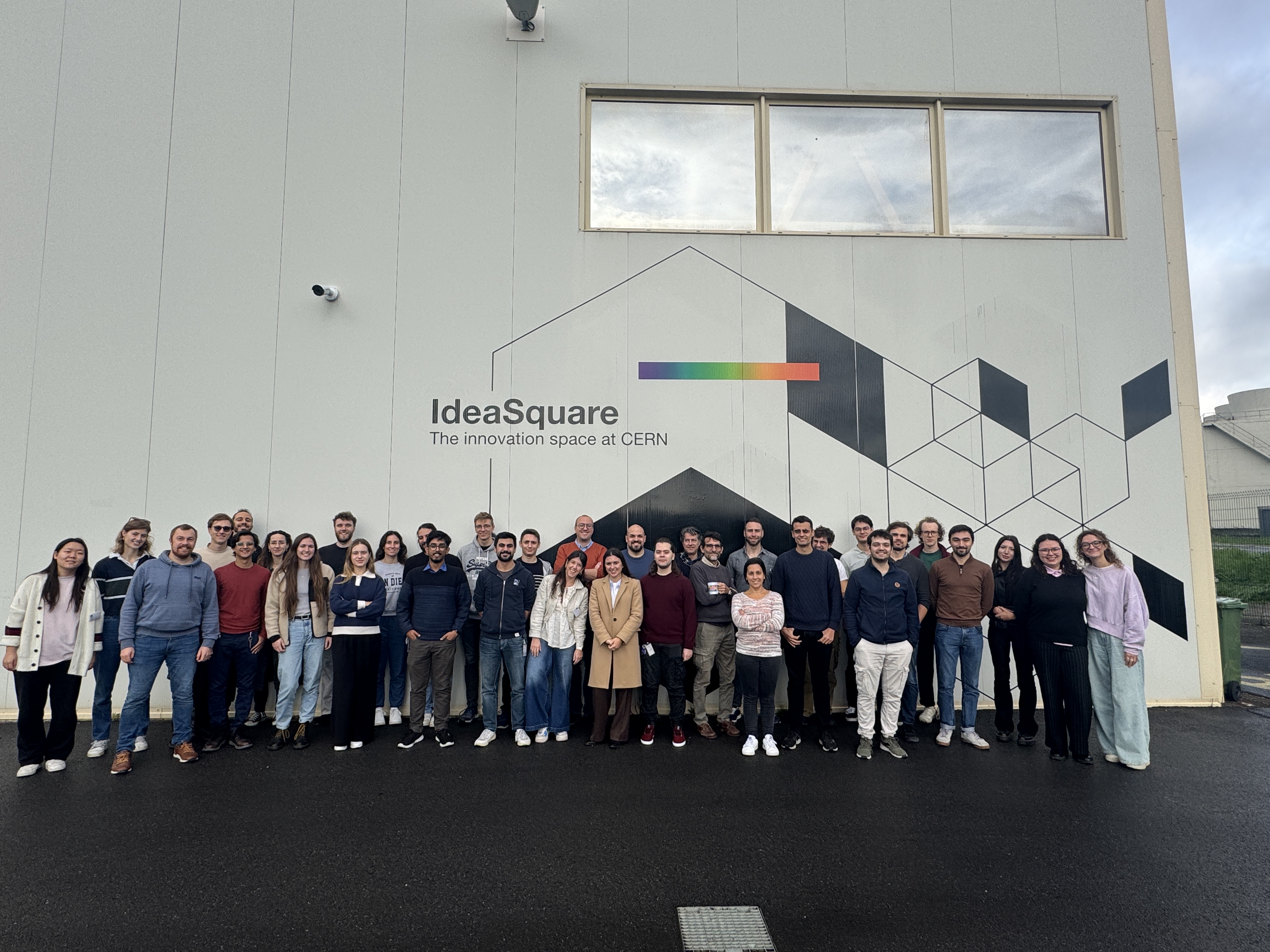 Group photo of the NGT Hackathon team in front of the IdeaSquare, at CERN.